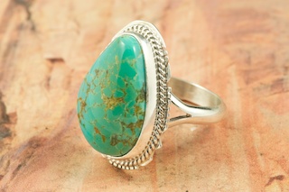 Genuine Manassa Turquoise set in Sterling Silver Ring. This Turquoise is also referred to as King�s Manassa Turquoise. The Manassa Turquoise mine is located in Manassa, Conejos County, Colorado. Created by Navajo Artist Larson Lee. Signed.